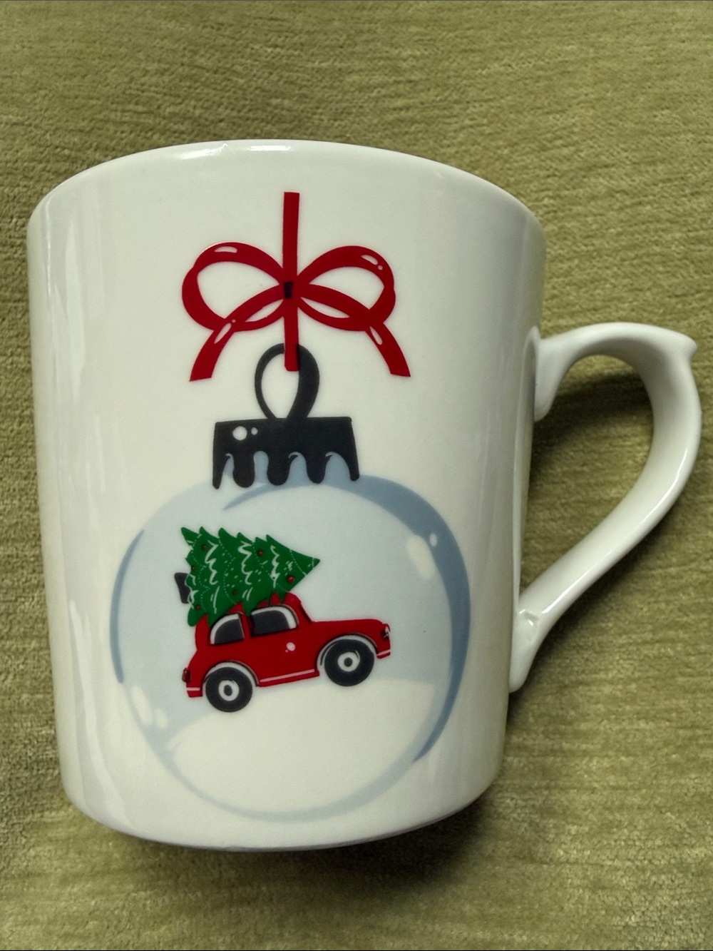 Maude Borup Mug Decorated w/ a Christmas Tree Atop a Red Car in a Round Ornament